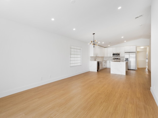 4524 Concordia Ln, Boynton Beach, FL 33436 - unfurnished living room with a chandelier, recessed lighting, lofted ceiling, and light wood-style floors