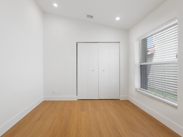 4524 Concordia Ln, Boynton Beach, FL 33436 - unfurnished bedroom with light wood-style flooring, recessed lighting, a closet, and vaulted ceiling