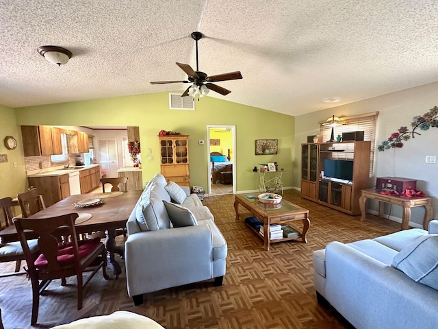 living area featuring visible vents, a textured ceiling, baseboards, lofted ceiling, and ceiling fan