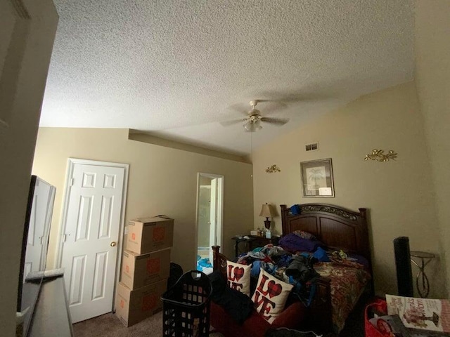 bedroom featuring visible vents, a textured ceiling, carpet flooring, ceiling fan, and vaulted ceiling