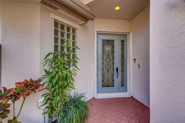 property entrance with stucco siding