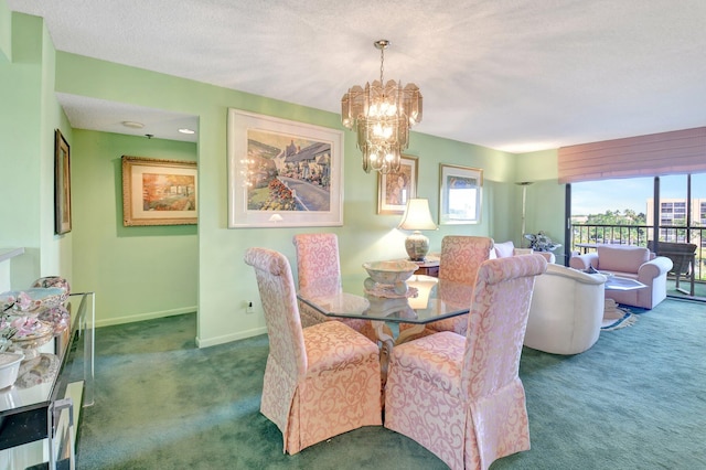 dining room with a textured ceiling, baseboards, carpet floors, and a chandelier