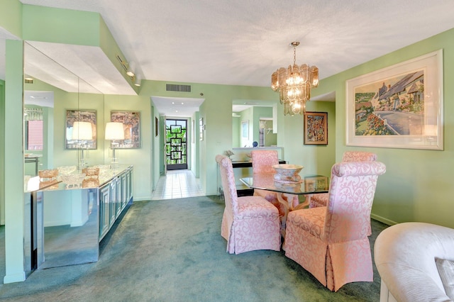 carpeted dining room with a chandelier, visible vents, and baseboards