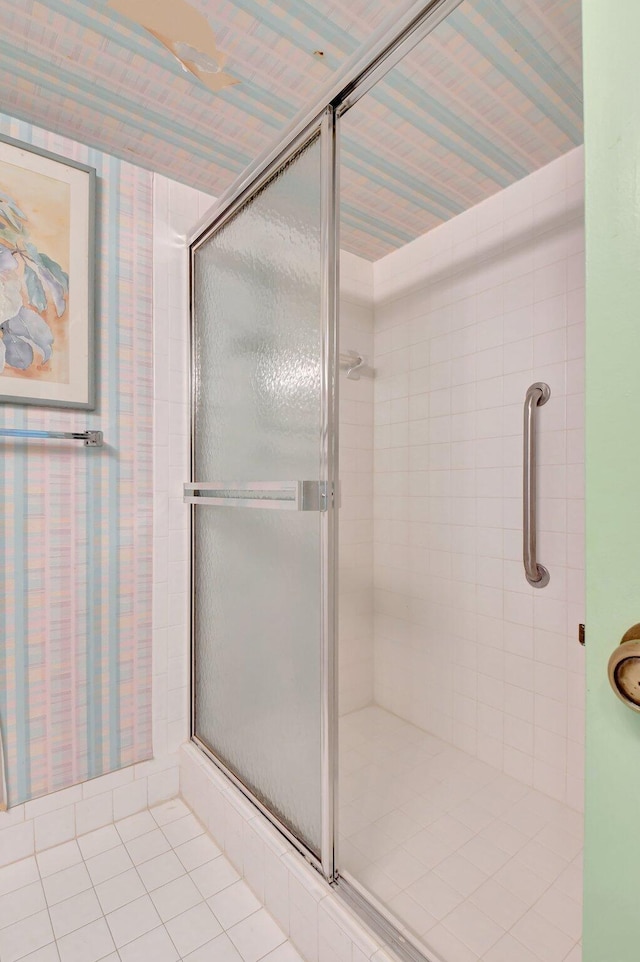 full bathroom with tile patterned floors and a shower stall