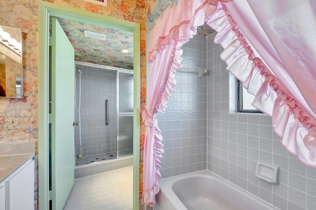 full bath with wallpapered walls, vanity, and combined bath / shower with glass door