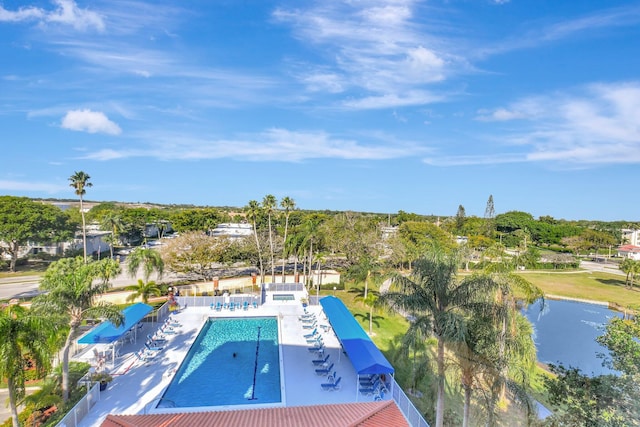 view of swimming pool with a patio area and a water view