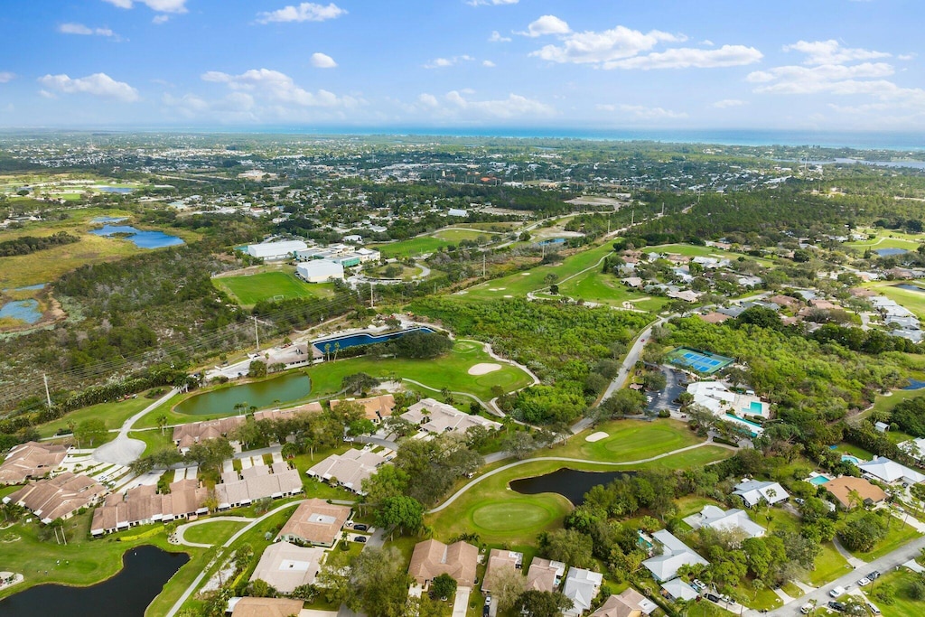 drone / aerial view featuring a residential view, a water view, and view of golf course