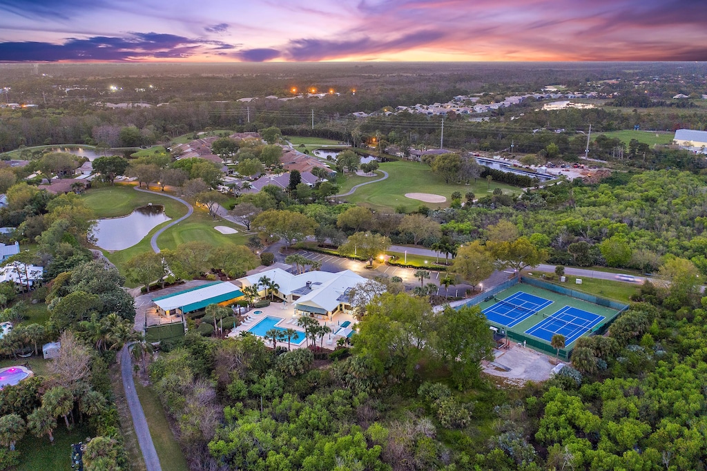 aerial view with a water view and view of golf course