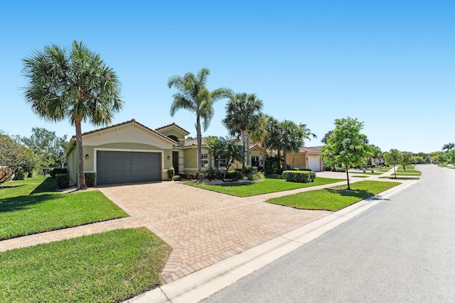 view of front facade with a front lawn, decorative driveway, an attached garage, and stucco siding