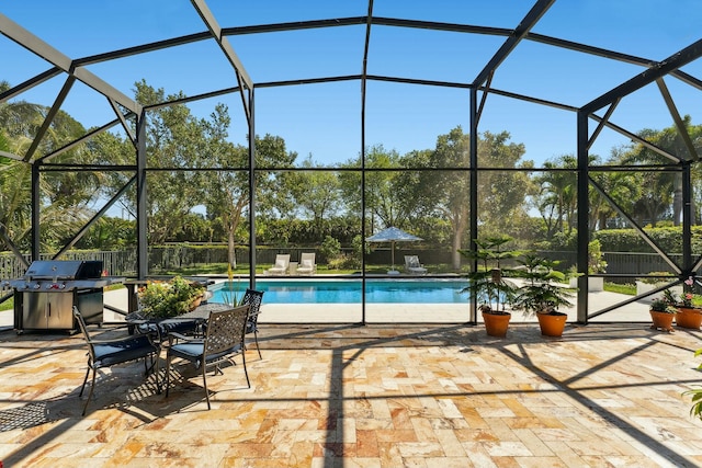 view of swimming pool featuring glass enclosure, a fenced in pool, grilling area, and a patio area