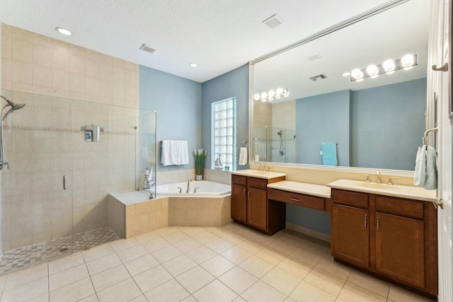 bathroom featuring visible vents, a bath, a shower stall, and tile patterned flooring