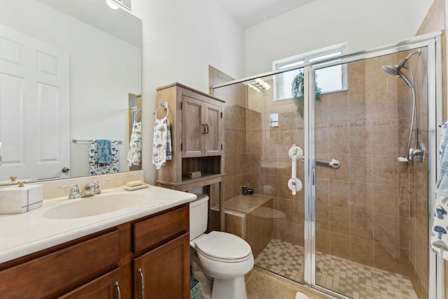 bathroom with toilet, a stall shower, vanity, and tile patterned flooring