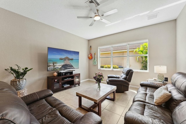 living room with light tile patterned floors, visible vents, baseboards, and ceiling fan