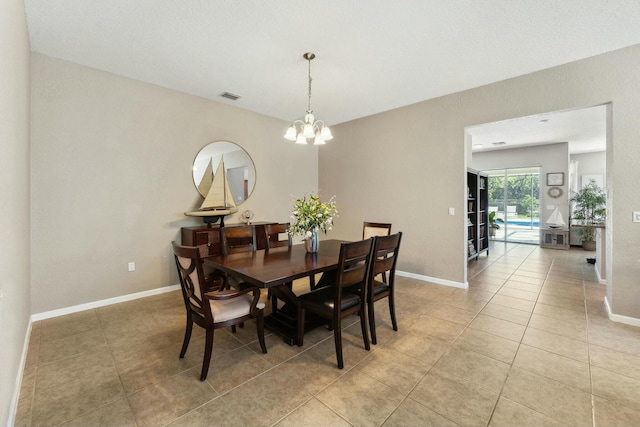 dining area with light tile patterned floors, visible vents, baseboards, and an inviting chandelier