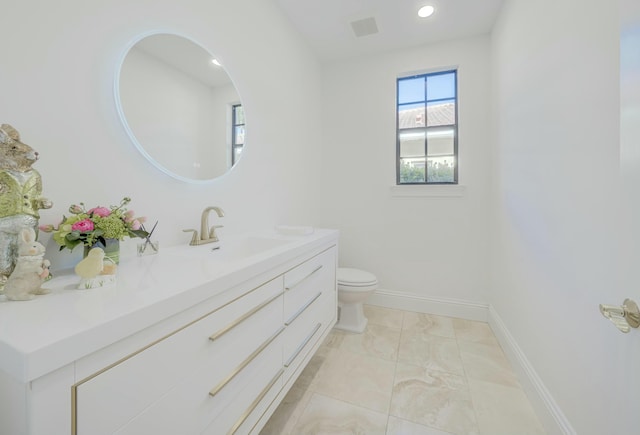 bathroom featuring recessed lighting, baseboards, toilet, and vanity