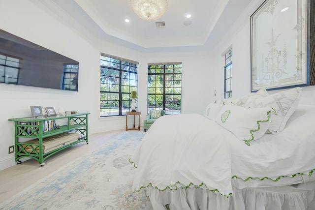 bedroom with wood finished floors, visible vents, baseboards, recessed lighting, and a raised ceiling