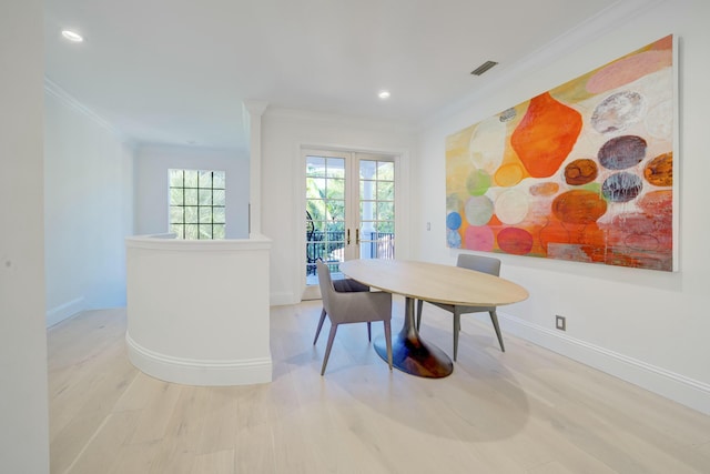 dining area with wood finished floors, french doors, visible vents, and ornamental molding