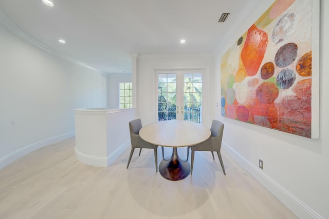 dining room with wood finished floors, baseboards, and ornamental molding