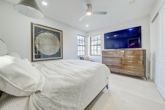 bedroom with a closet, recessed lighting, a ceiling fan, and wood finished floors