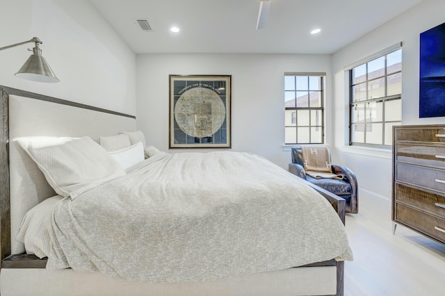 bedroom with visible vents, recessed lighting, baseboards, and wood finished floors