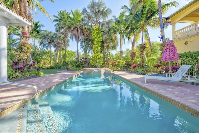 view of swimming pool featuring a patio and a pool with connected hot tub