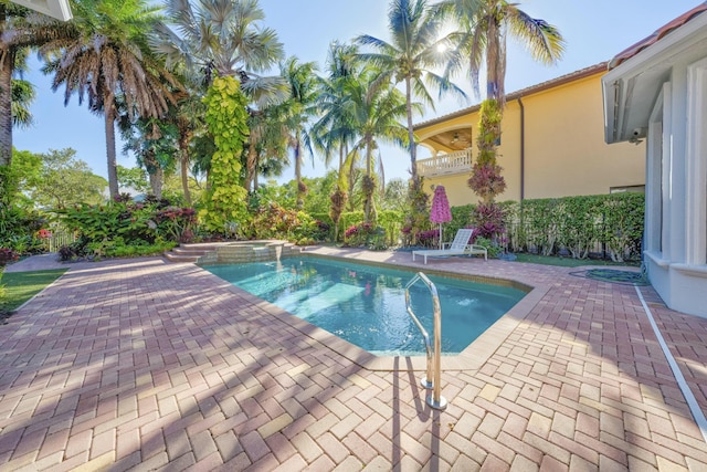 view of pool featuring a patio and a pool with connected hot tub