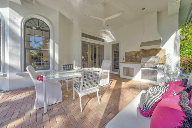 view of patio / terrace featuring a sink, exterior kitchen, outdoor dining area, and a grill