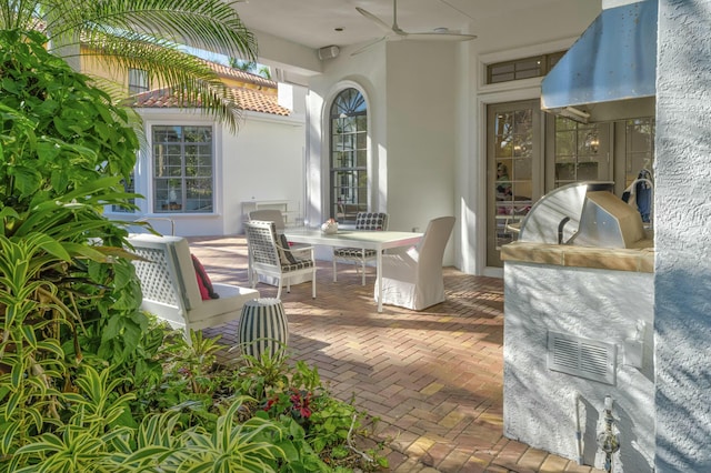 view of patio / terrace with visible vents, outdoor dining space, and exterior kitchen