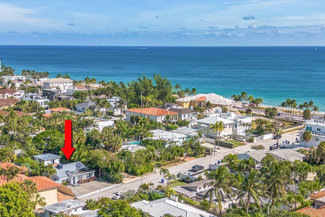 drone / aerial view with a water view and a residential view