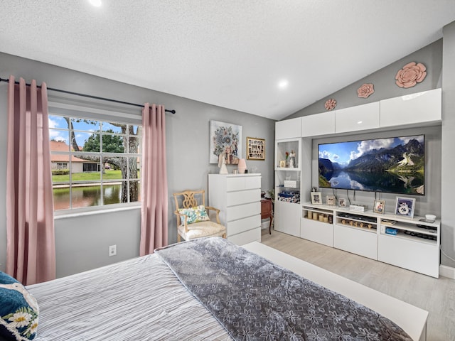 7882 Lake Sands Dr, Delray Beach, FL 33446 - bedroom with lofted ceiling, light wood-style floors, and a textured ceiling