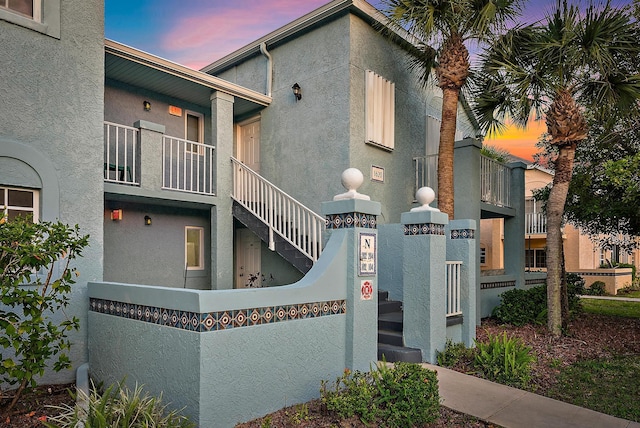 property exterior at dusk with stucco siding