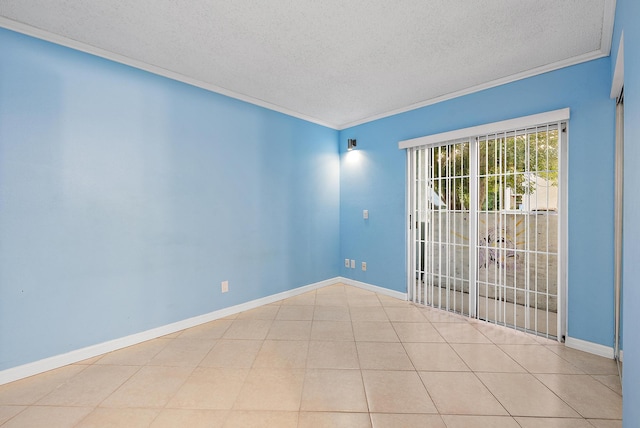 tiled empty room featuring baseboards, a textured ceiling, and crown molding