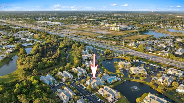 birds eye view of property with a residential view and a water view
