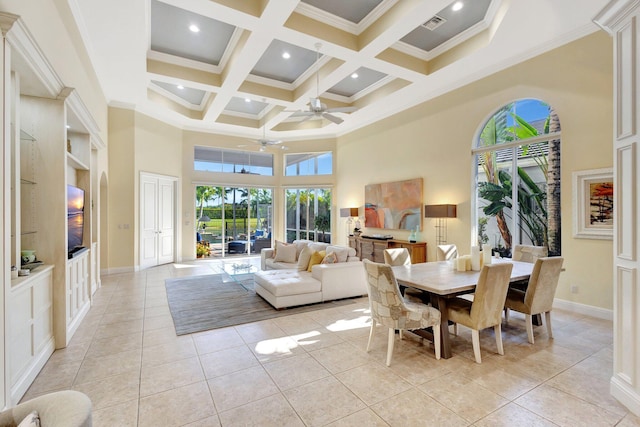 dining room with beam ceiling, light tile patterned floors, a towering ceiling, coffered ceiling, and a ceiling fan