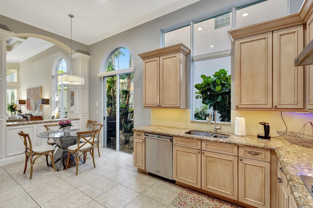 kitchen with light brown cabinetry, dishwasher, tasteful backsplash, and a sink