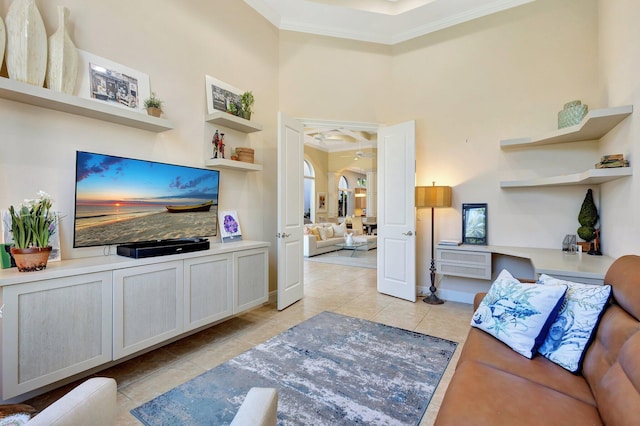 living room featuring baseboards, ornamental molding, arched walkways, a high ceiling, and light tile patterned flooring