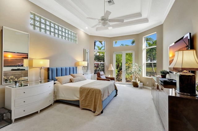 carpeted bedroom with visible vents, a tray ceiling, french doors, a towering ceiling, and crown molding