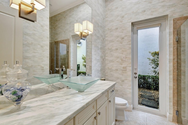 bathroom featuring tile patterned floors, toilet, vanity, and crown molding