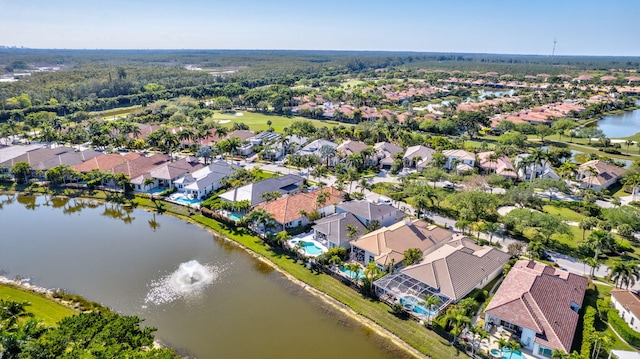 drone / aerial view with a residential view and a water view