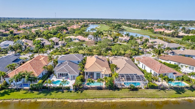 drone / aerial view with a residential view and a water view