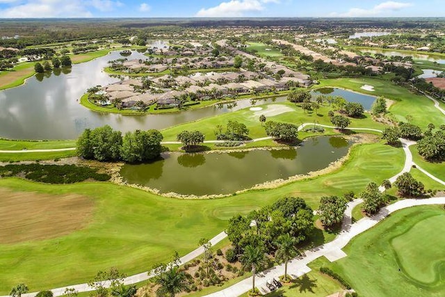 birds eye view of property with a water view and golf course view