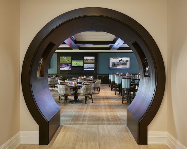 dining space with baseboards and arched walkways