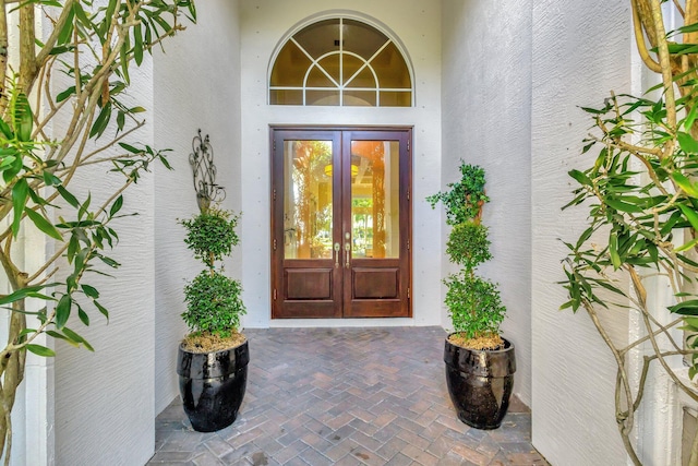 property entrance with french doors and stucco siding