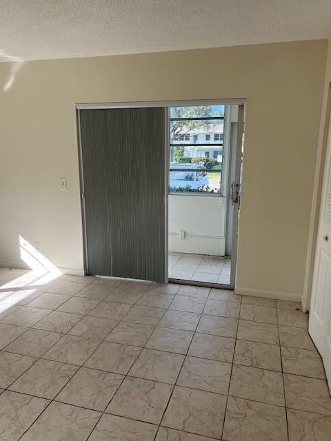 unfurnished room featuring a textured ceiling