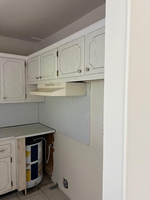 kitchen with light countertops and water heater