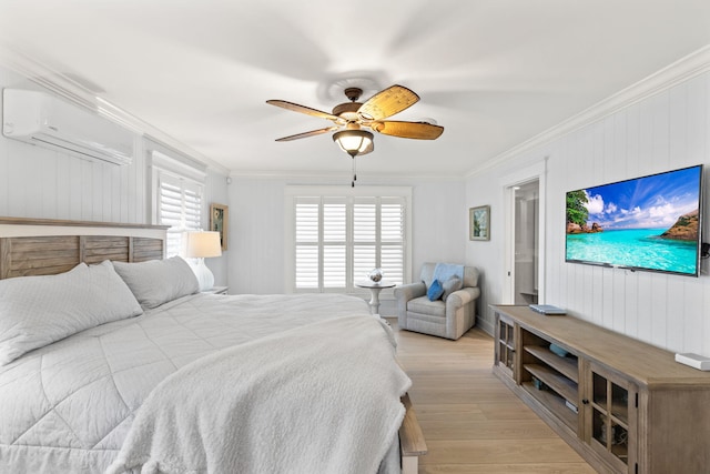 bedroom with ornamental molding, a ceiling fan, light wood-style floors, and a wall unit AC