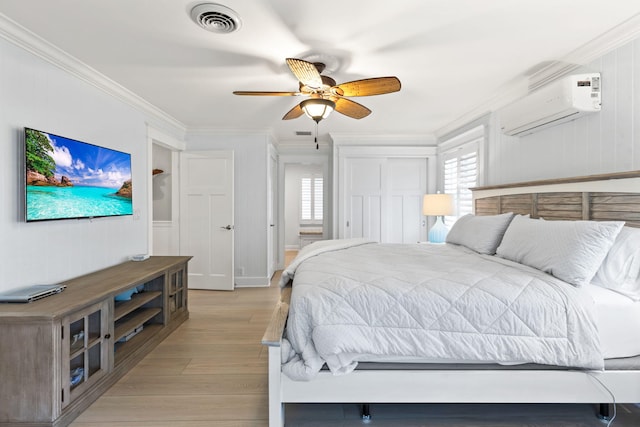 bedroom with visible vents, a wall mounted air conditioner, ornamental molding, ceiling fan, and light wood-style floors
