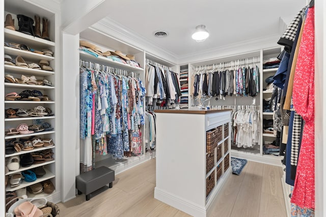 walk in closet featuring wood finished floors and visible vents