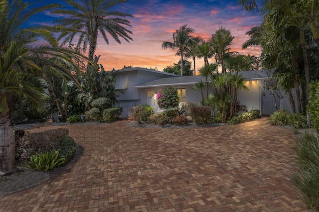 view of front of property featuring decorative driveway and stucco siding