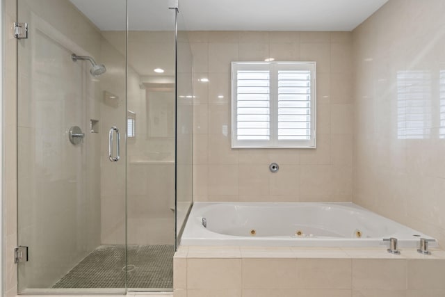 bathroom featuring a shower stall and a whirlpool tub